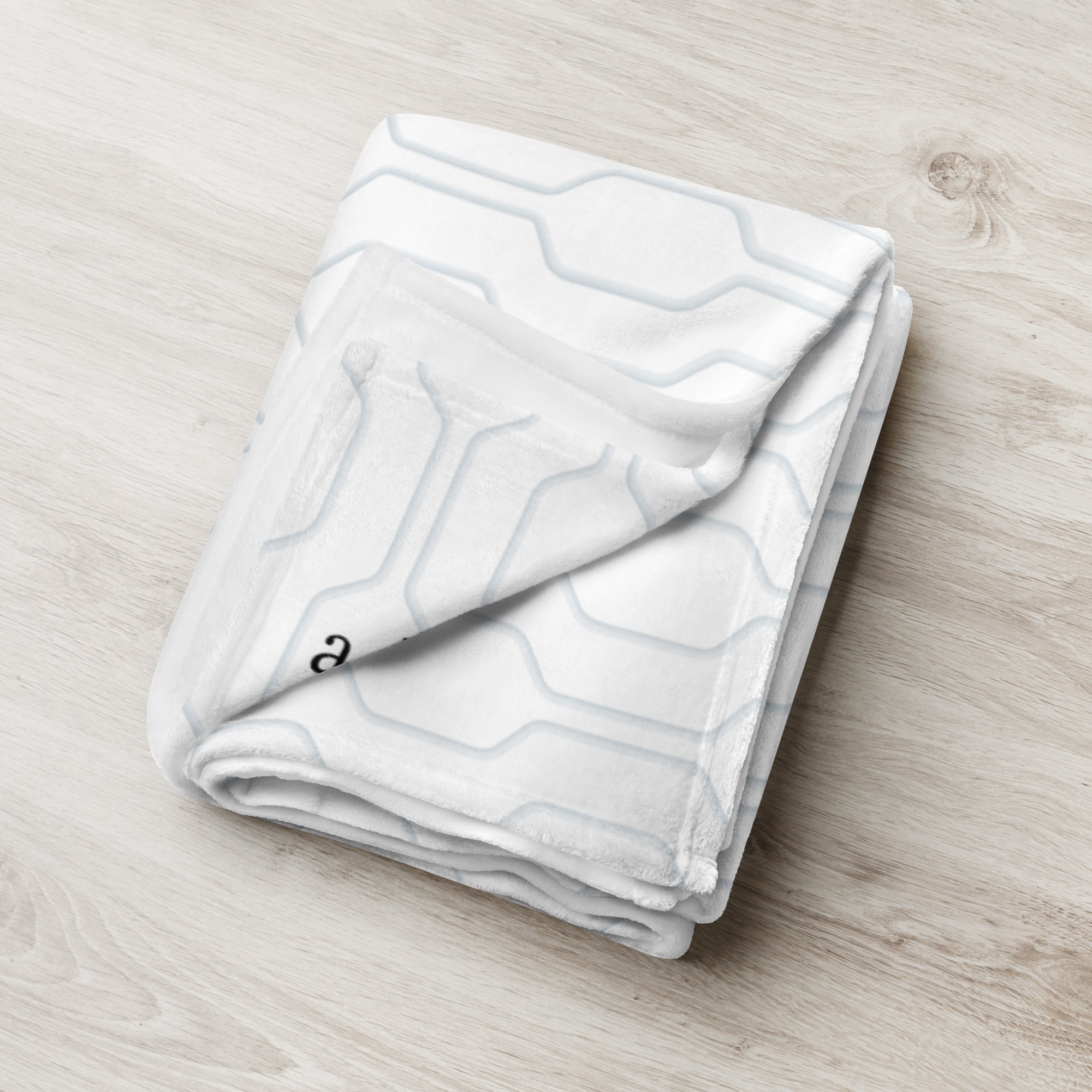 Folded blanket with blue modern pattern. Blanket has text that says, "a hug from Austin.” Support gift for granddaughter or grandson.