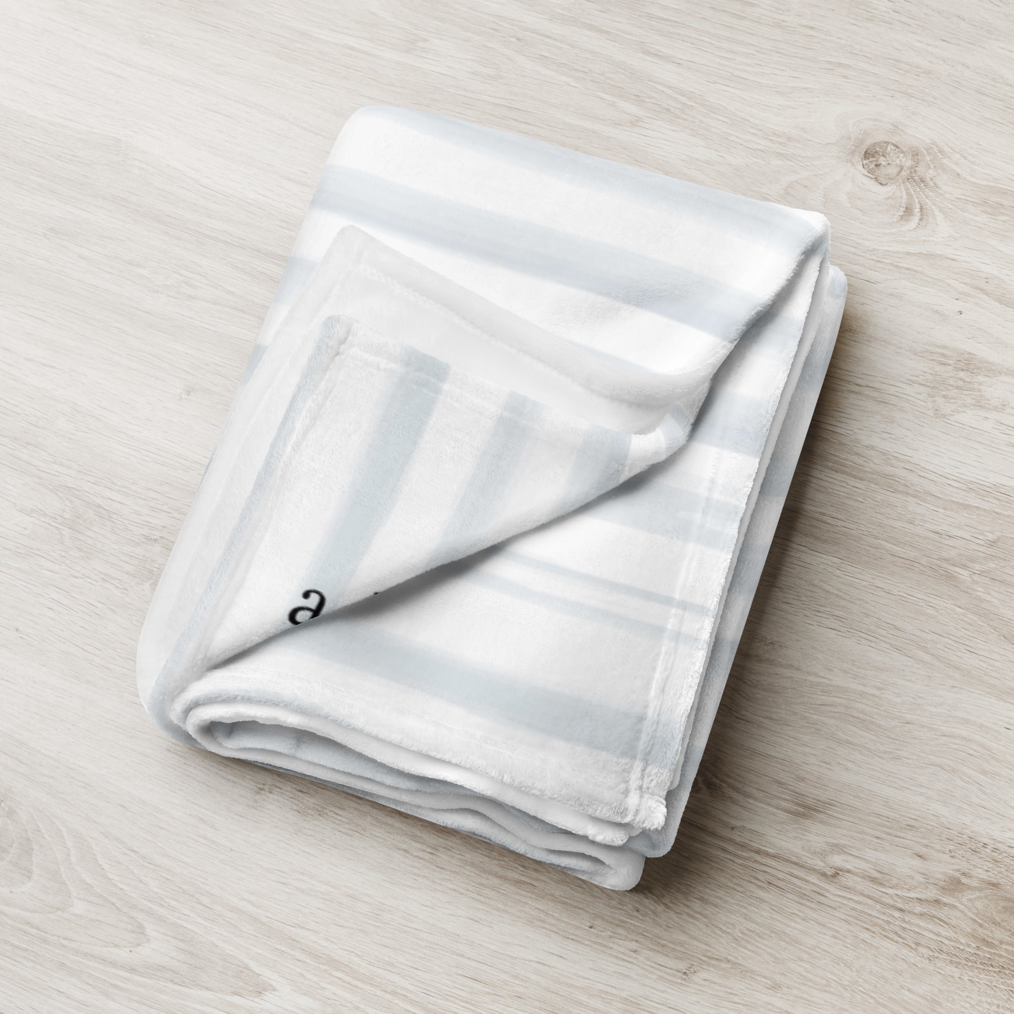 Folded blanket with blue modern striped pattern. Blanket has text that says, "a hug from Melissa.” Support gift for granddaughter or grandson.