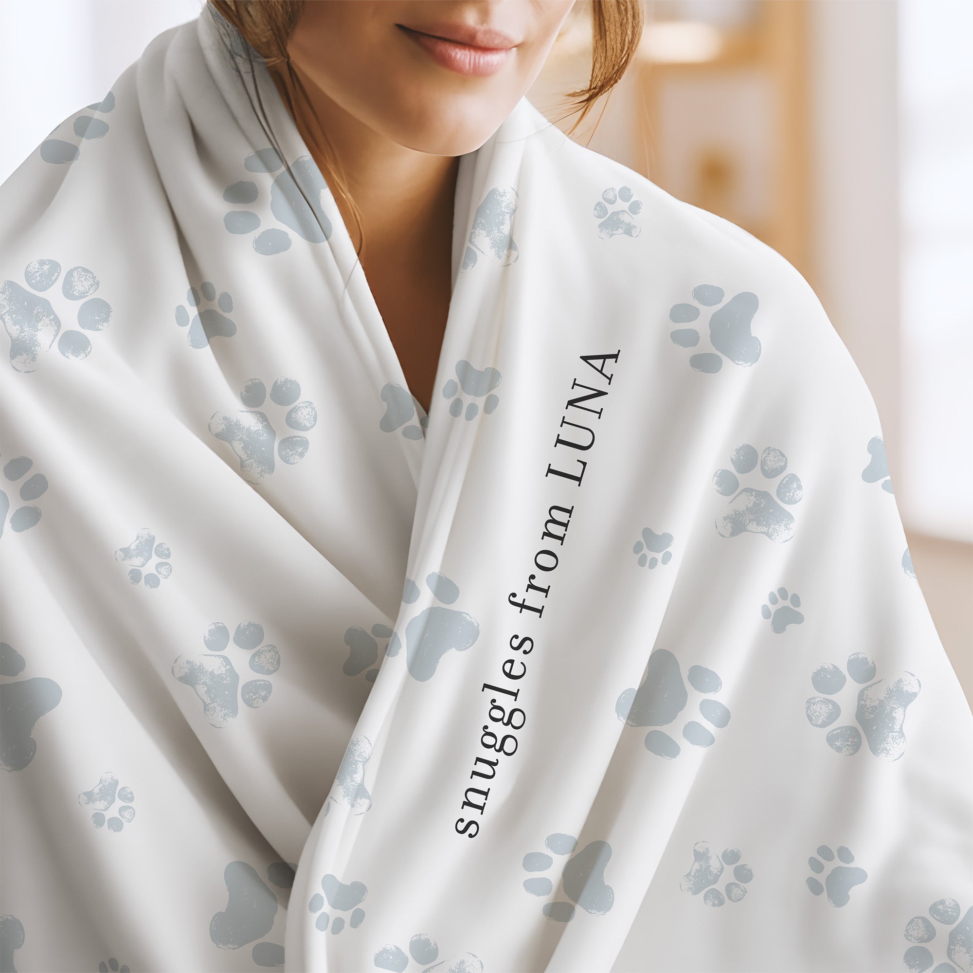 Send a hug memorial blanket with white and blue paw print pattern and the words “snuggles from Luna.” Sympathy gift for cat or dog.