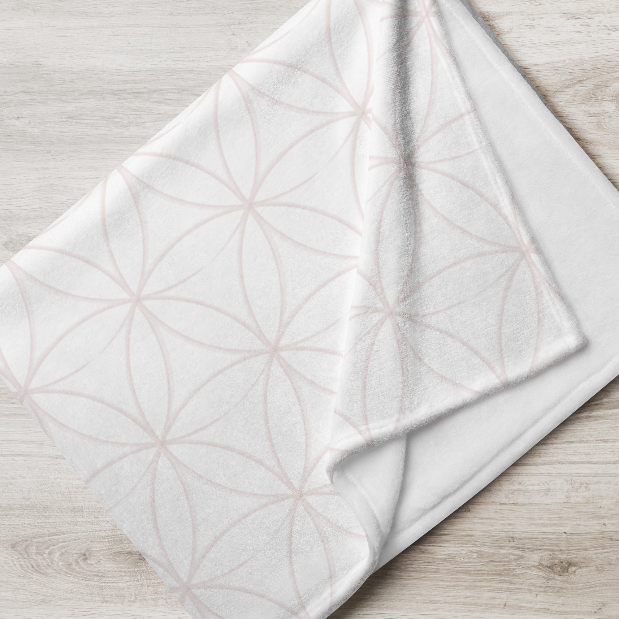 Folded blanket with pale pink overlapping modern circles pattern. Blanket has text that says, "a hug from Nicole.” Sympathy gift for loss of child.
