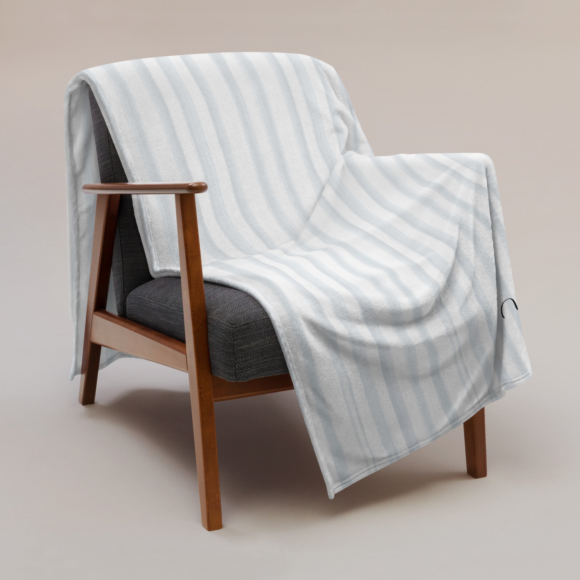 Personalized super soft blanket with blue stripes draped over a chair. Blanket has text that says, "a hug from Melissa.” Support gift for son or daughter at college.
