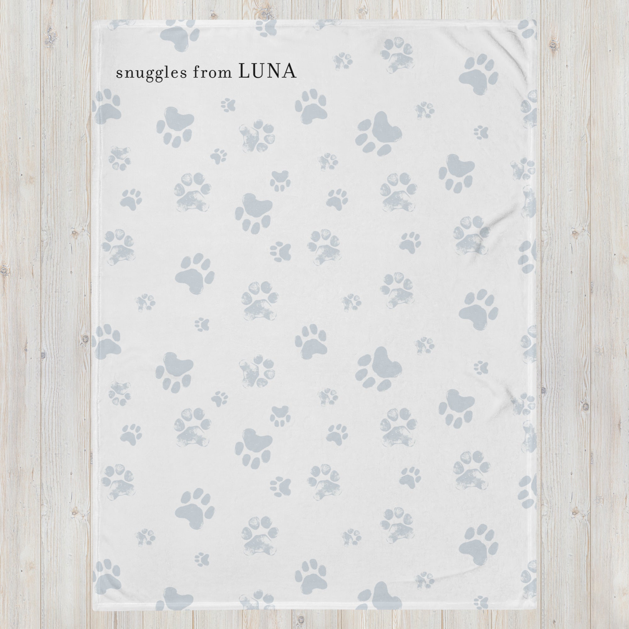 Send a hug sympathy gift blanket with white and light blue paw print pattern and the words “snuggles from Luna.” Sympathy gift for loss of pet.